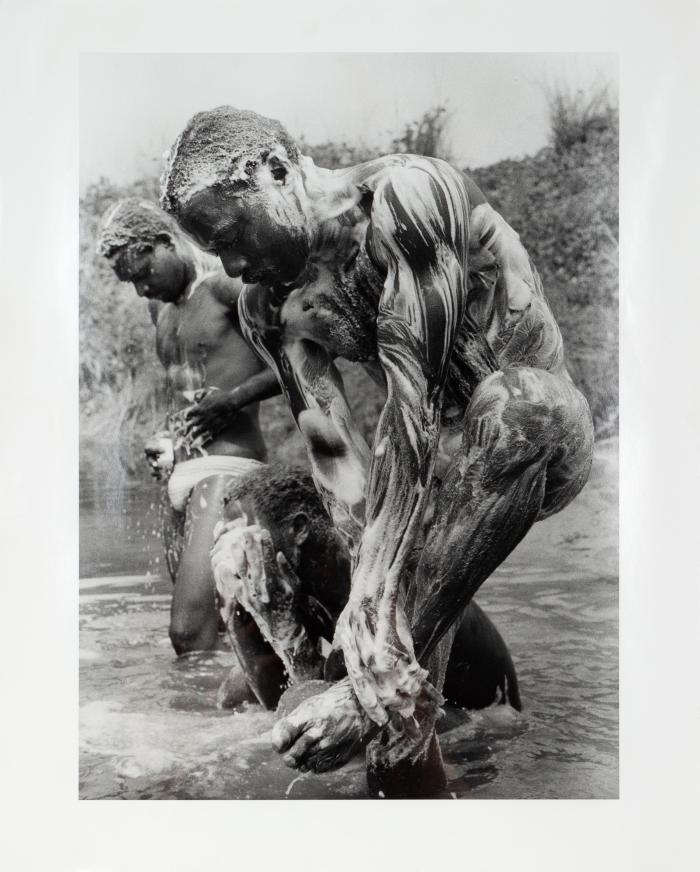 Truck drivers bathing in river Lombaréré in Gabon 1989